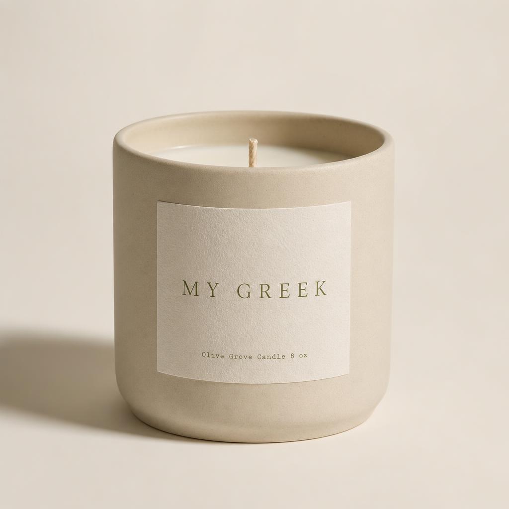 Cream vessel candle with a letterpress label bearing the MY GREEK mark