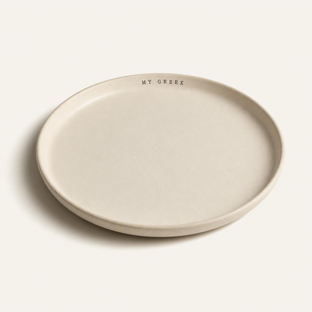 Matte cream stoneware dinner plate with MY GREEK stamped on the rim